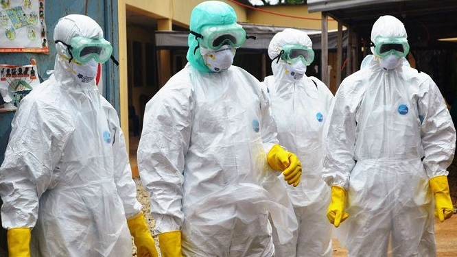 Health workers wearing protective gear against Ebola. /AP