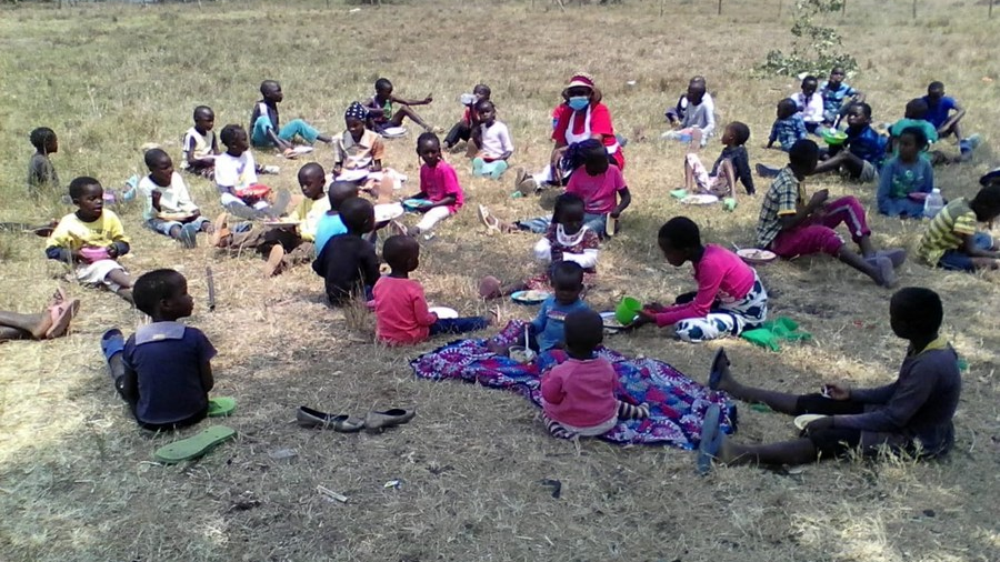 Children seated in a field in Kenya. /Xinhua