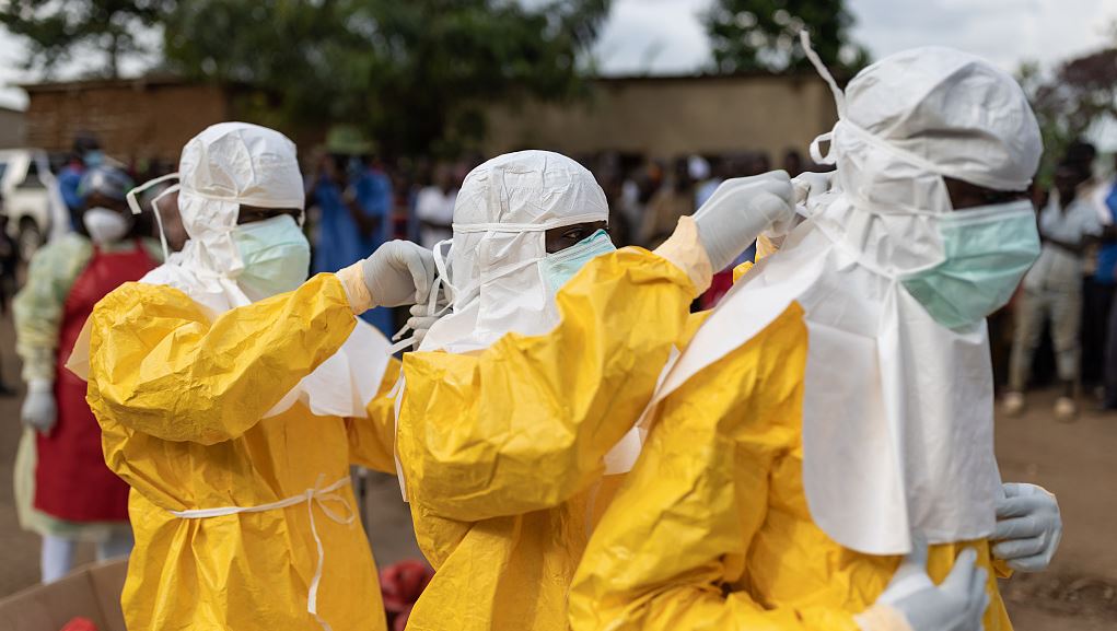 Red Cross workers don PPE prior to burying a 3-year-old boy suspected of dying from Ebola on October 13, 2022 in Mubende, Uganda. /Getty Images
