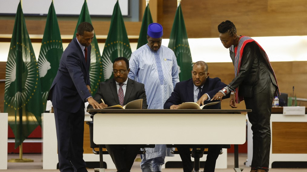 Redwan Hussien Rameto, Representative of the Ethiopian government, and Getachew Reda, Representative of the Tigray People's Liberation Front (both seated), sign a peace agreement between the two parties during a press conference regarding the African Union-led negotiations to resolve conflict in #Ethiopia, on Wednesday, November 2, in Pretoria, South Africa. /AP