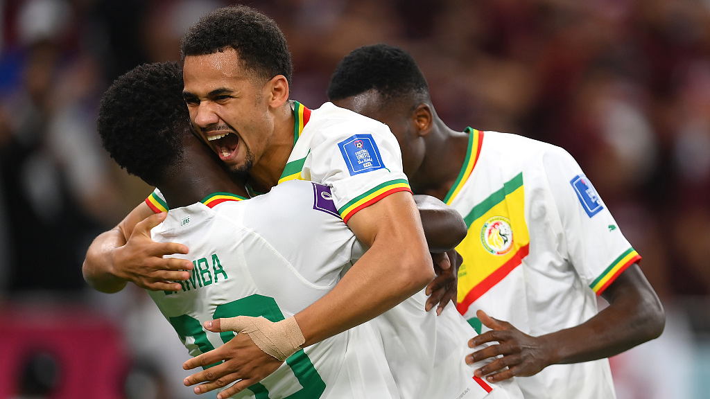 Senegal celebrates with teammates after scoring their team's third goal during the FIFA World Cup Qatar 2022 Group A match between Qatar and Senegal at Al Thumama Stadium on November 25, 2022 in Doha, Qatar. /Getty Images)