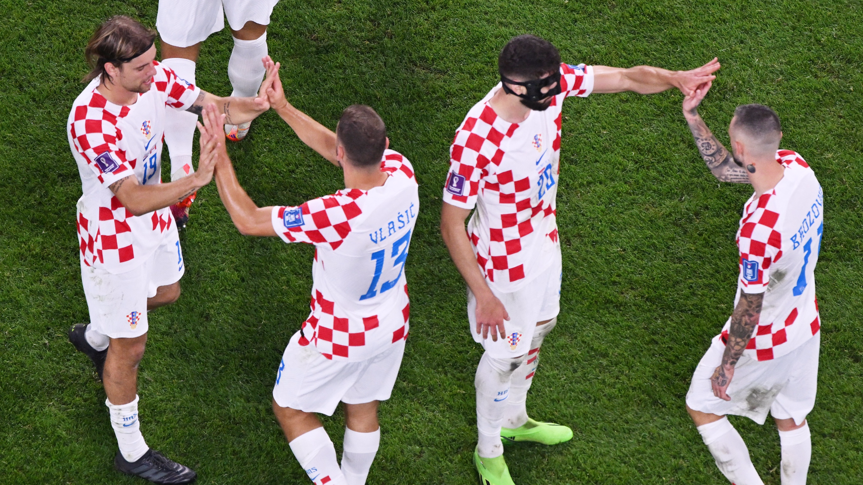 Croatia players celebrate after Croatia's midfielder #07 Lovro Majer (not seen) scored their team's fourth goal during the Qatar 2022 World Cup on November 27, 2022. /AFP