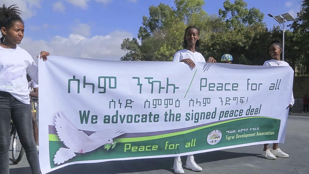 Girls hold a banner in support of the recent peace deal agreed between the Ethiopian federal government and Tigray forces, at a street carnival organized by the Tigray Development Association, in Mekele, the capital of the Tigray region, in northern Ethiopia on Saturday, Nov. 26, 2022. /AP Photo