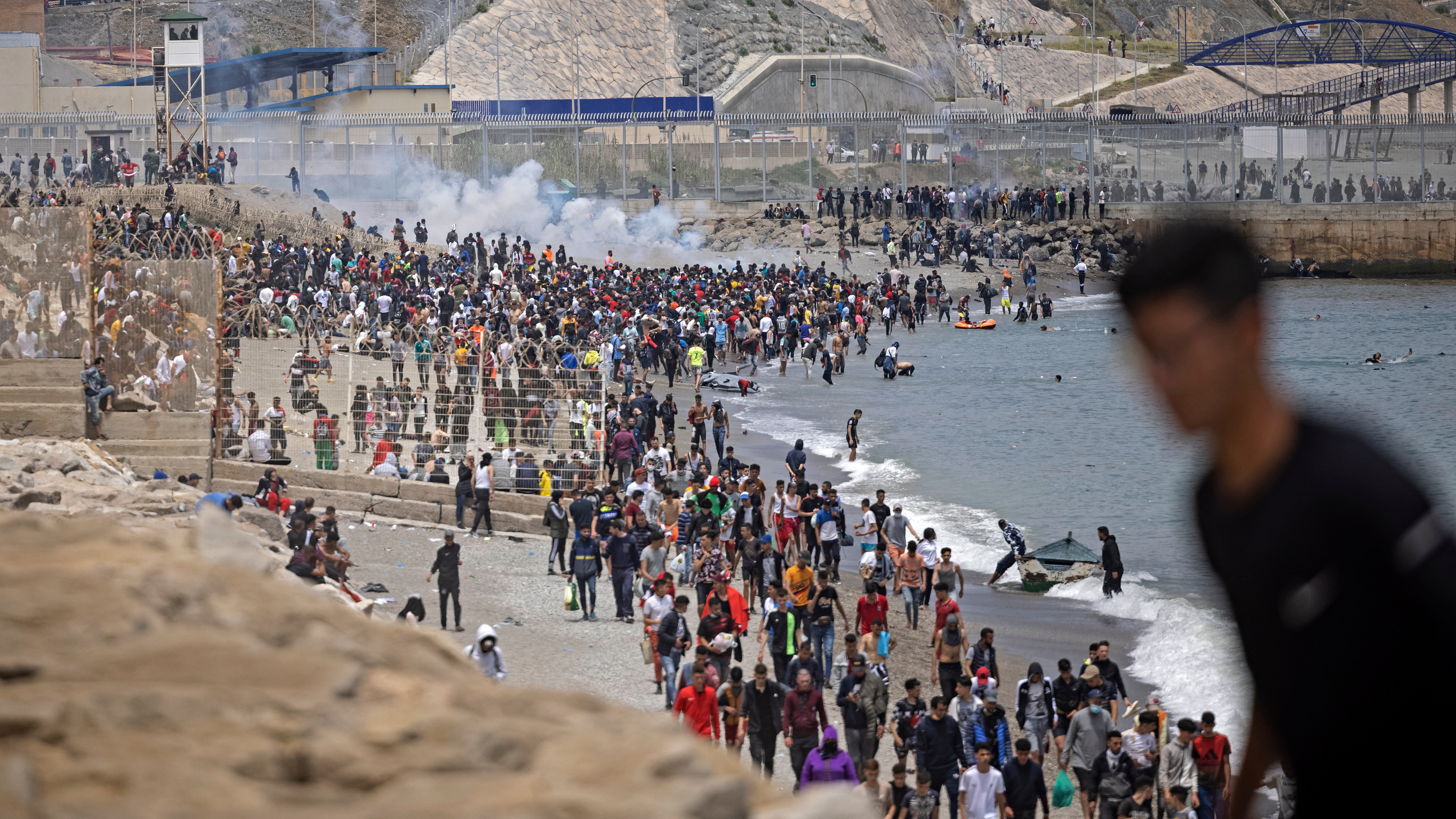 Spanish police try to disperse migrants at a border between Morocco and the Spanish enclave of Ceuta. /AFP