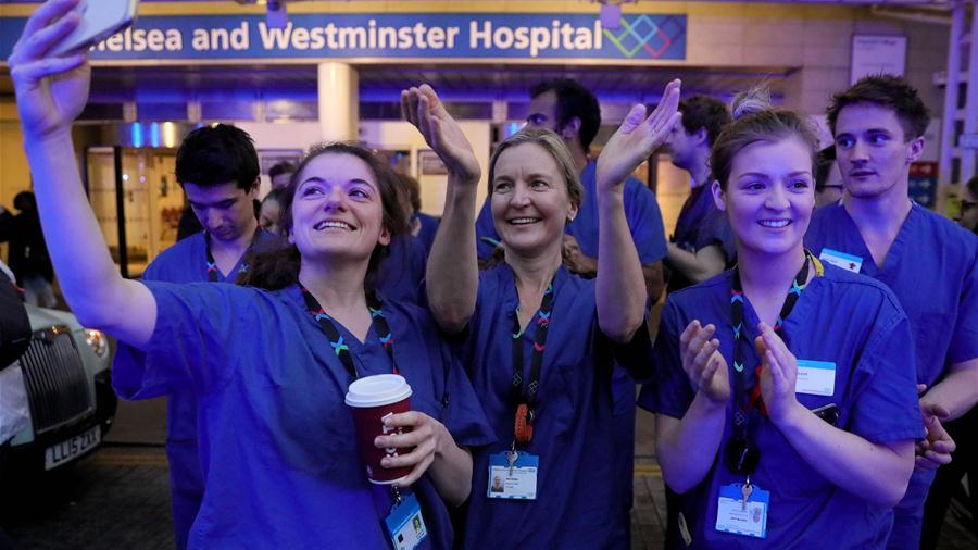Medical workers applaud outside Chelsea and Westminster Hospital during the weekly clap for the NHS (National Health Service) in London, Britain on April 16, 2020. /Xinhua