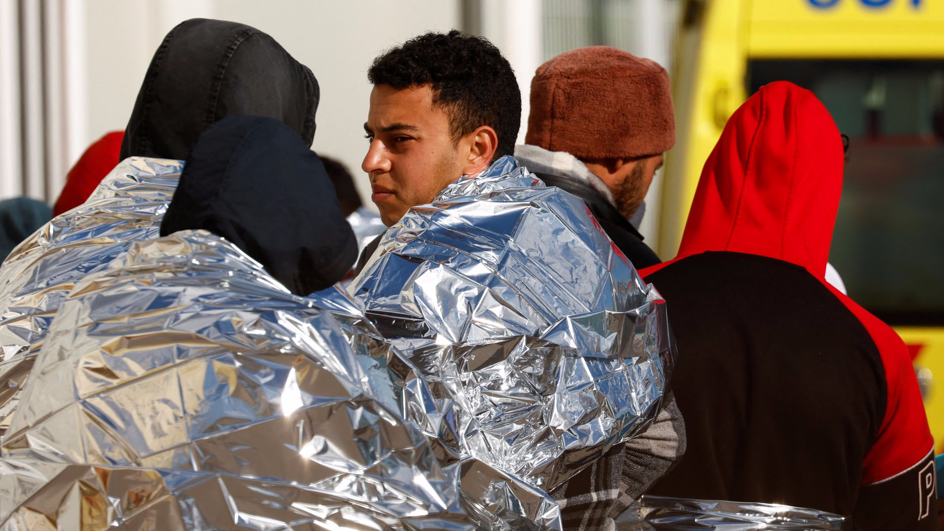 Migrants rescued by a merchant vessel cover themselves with emergency blankets in Malta, April 17, 2023. /Reuters