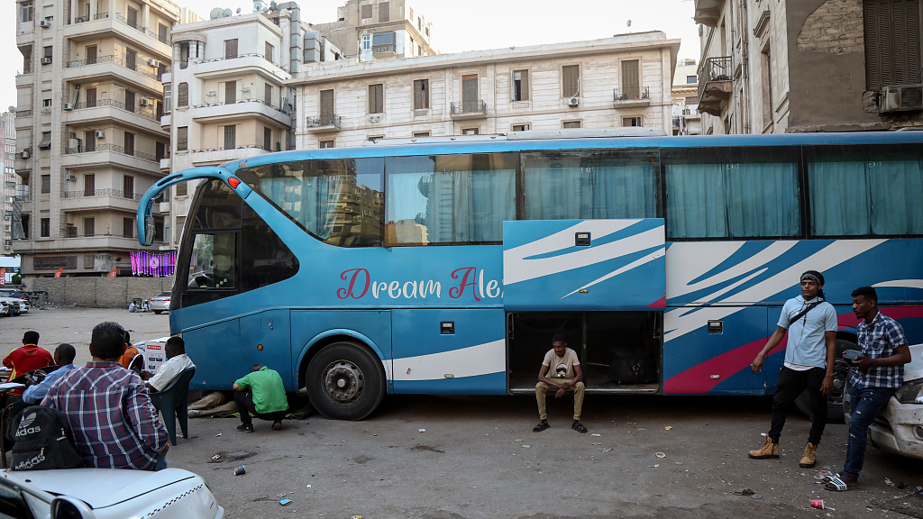 Sudanese people wait at a bus stop in downtown Cairo to return to their families with food on April 25, 2023 in Cairo, Egypt. /CFP