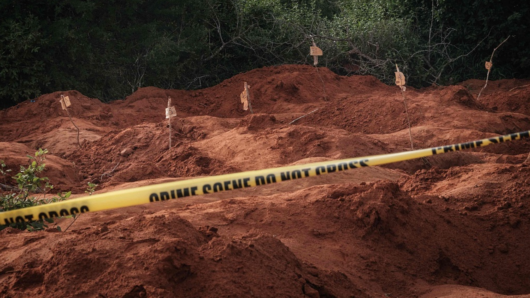 Holes left behind after exhuming bodies at the mass-grave site in Shakahola, outside the coastal town of Malindi, Kenya, on April 25, 2023. /CFP