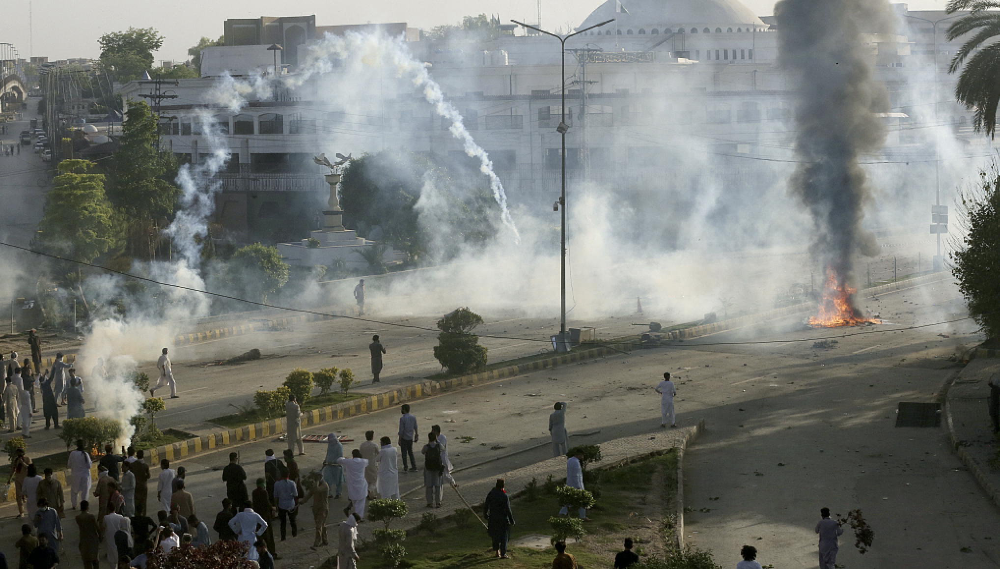 Police fire tear gas to disperse supporters of Pakistan's former Prime Minister Imran Khan protesting against the arrest of their leader, in Peshawar, Pakistan, Tuesday, May 9, 2023. /CFP