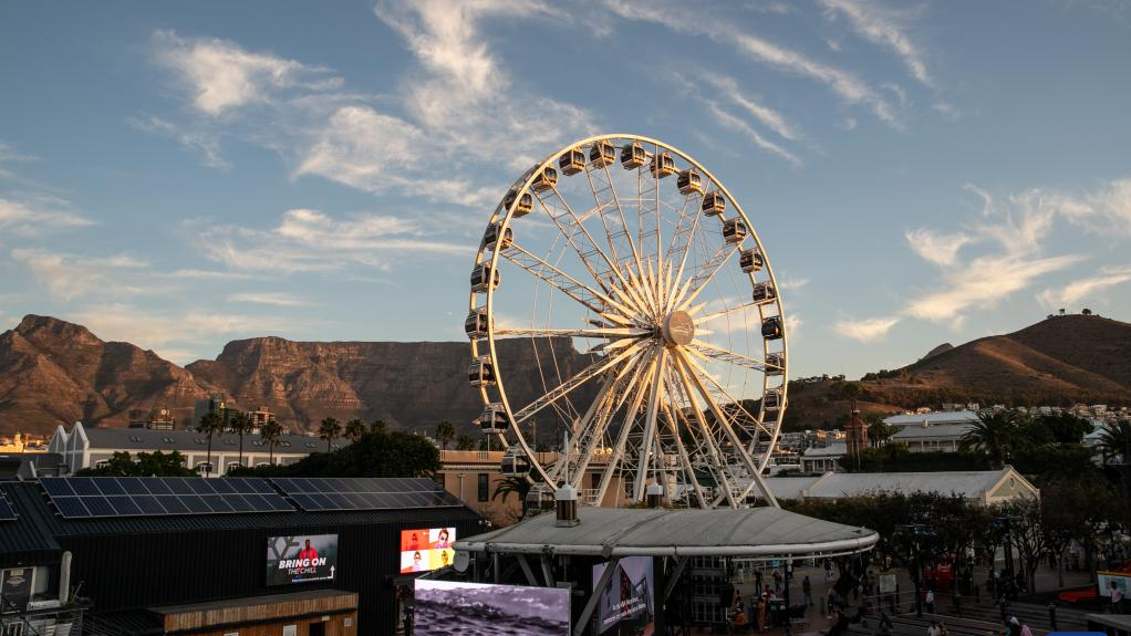 A sky wheel is seen at sunset at V&A Waterfront, a popular beach-side tourism attraction, in Cape Town, South Africa, on May 16, 2022. /Xinhua