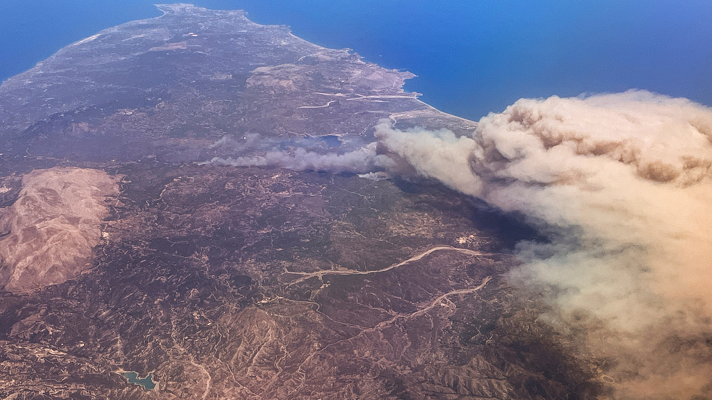 A photo taken from an airplane shows forest fires rage on the vacation island of Rhodes, Greece. /CFP