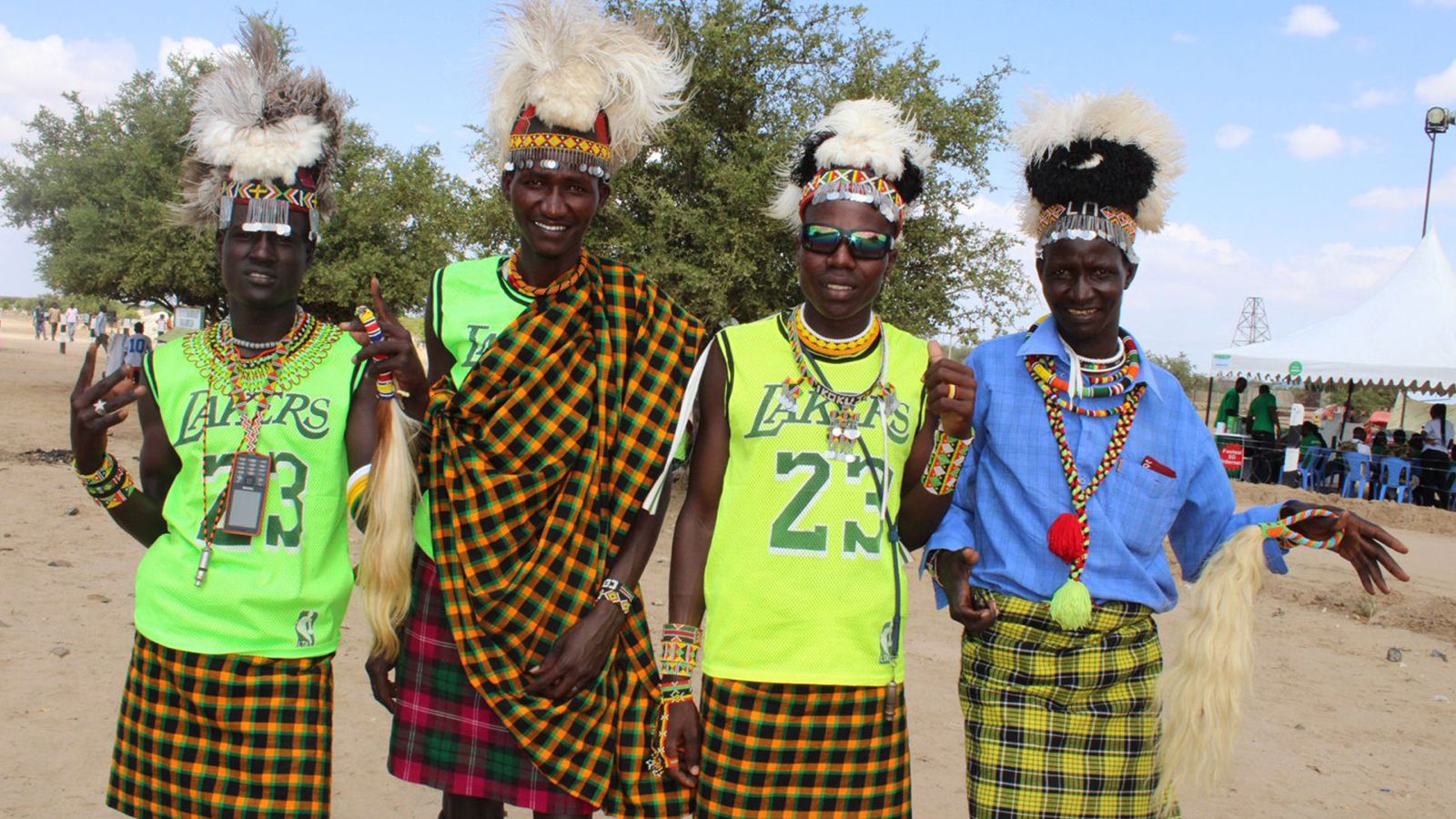 A group of men wearing traditional Turkana attire adorned with ostrich feathers pose for a photo at the Turkana Cultural Festival. /CGTN Africa