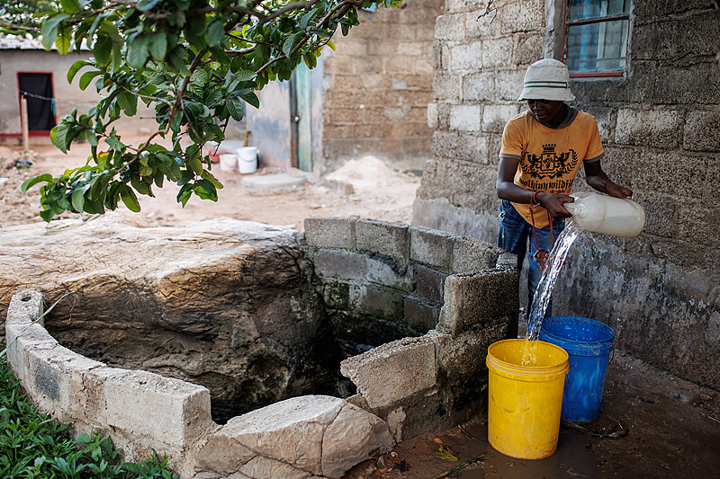 A boy fetches water from a shallow well in Lusaka, Zambia, February 24, 2024. /CFP