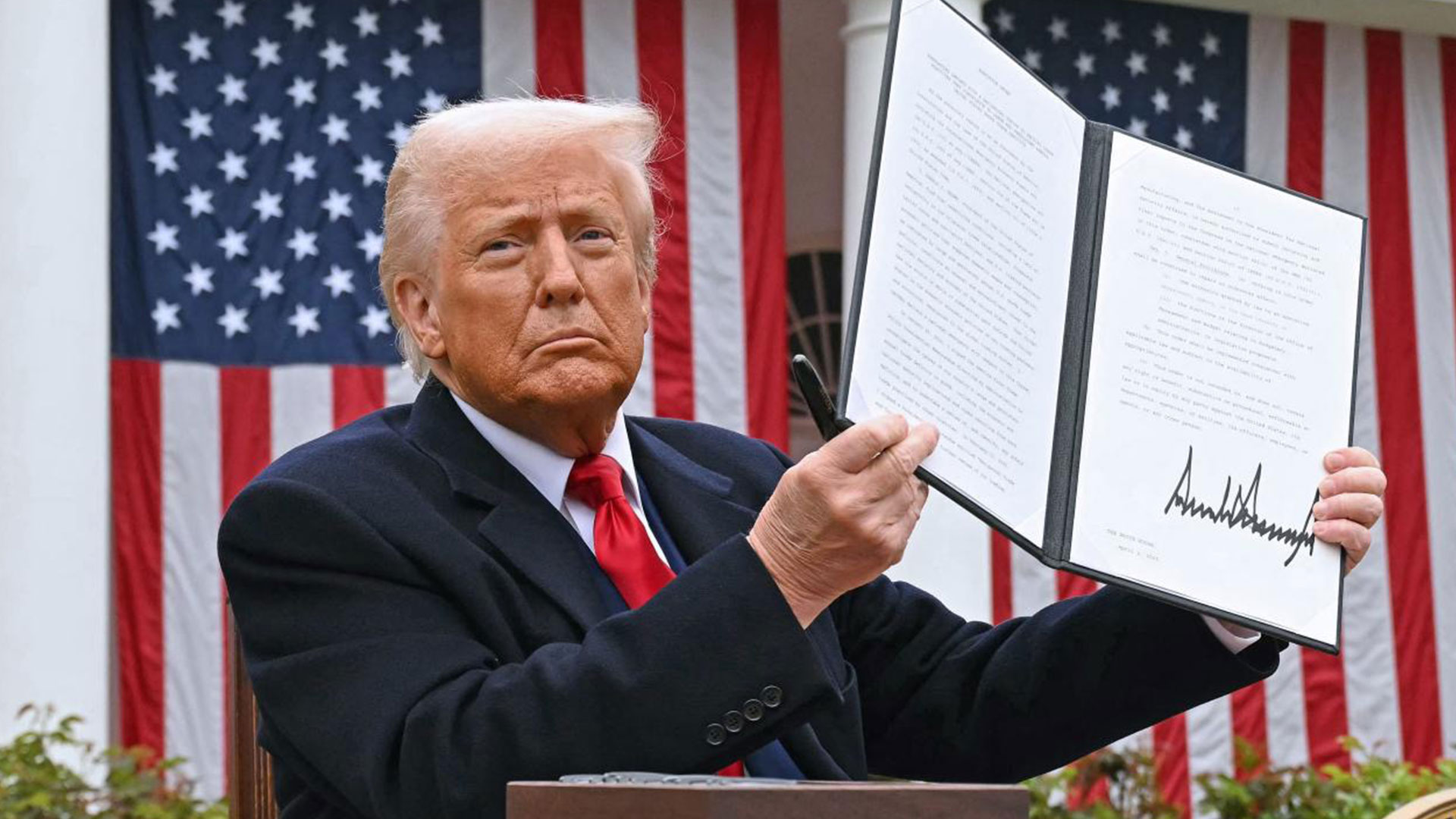 US President Donald Trump holds a signed executive order after delivering remarks on reciprocal tariffs during an event in the Rose Garden entitled 