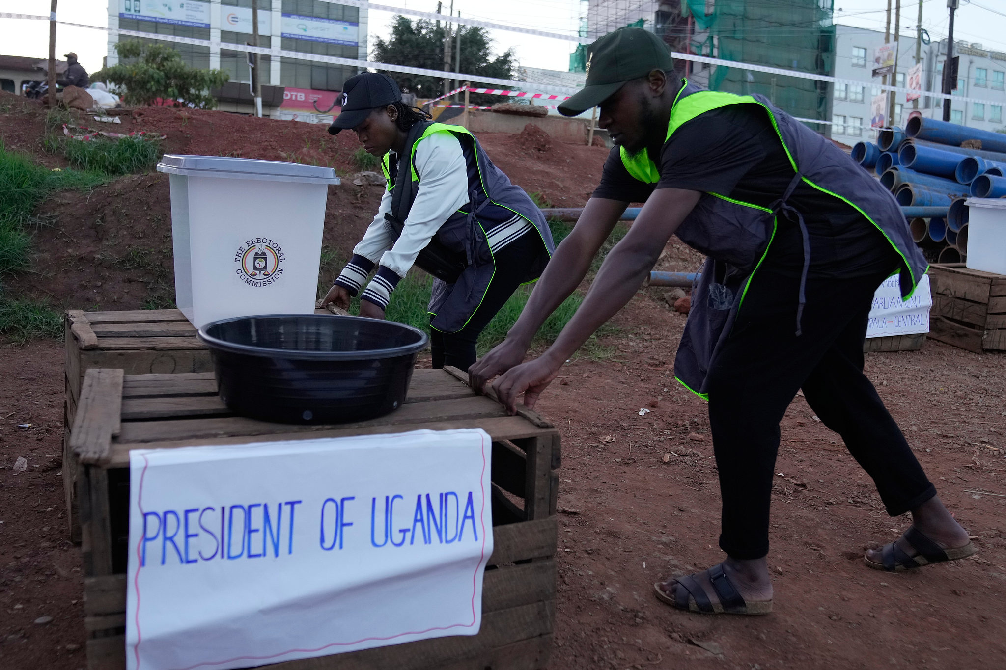 Electoral workers deliver ballot boxes to a polling station during presidential election in Kampala, Uganda, January 15, 2026. /AP