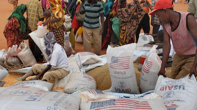 File Image: Workers distribute food aid from the World Food Programme at a refugee camp in Dolo, Somalia on July 18. 2012. /CFP