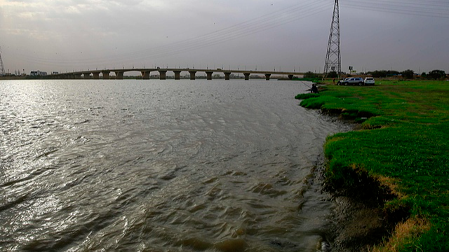 A fisherman casts his net into the Nile river in the Sudanese capital Khartoum on June 9, 2020. /CFP