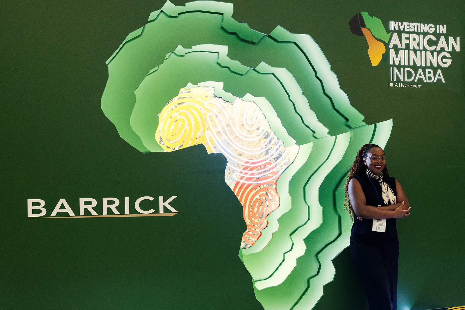 A delegate poses in front of a poster at the 32nd edition of the African Mining Indaba at the Cape Town International Convention Center, February 10, 2026, Cape Town, South Africa. /AFP