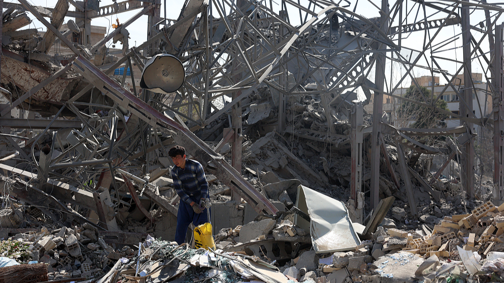 An Iranian worker cleans up damage to a building in the city center, Tehran, Iran, on March 4, 2026. /CFP