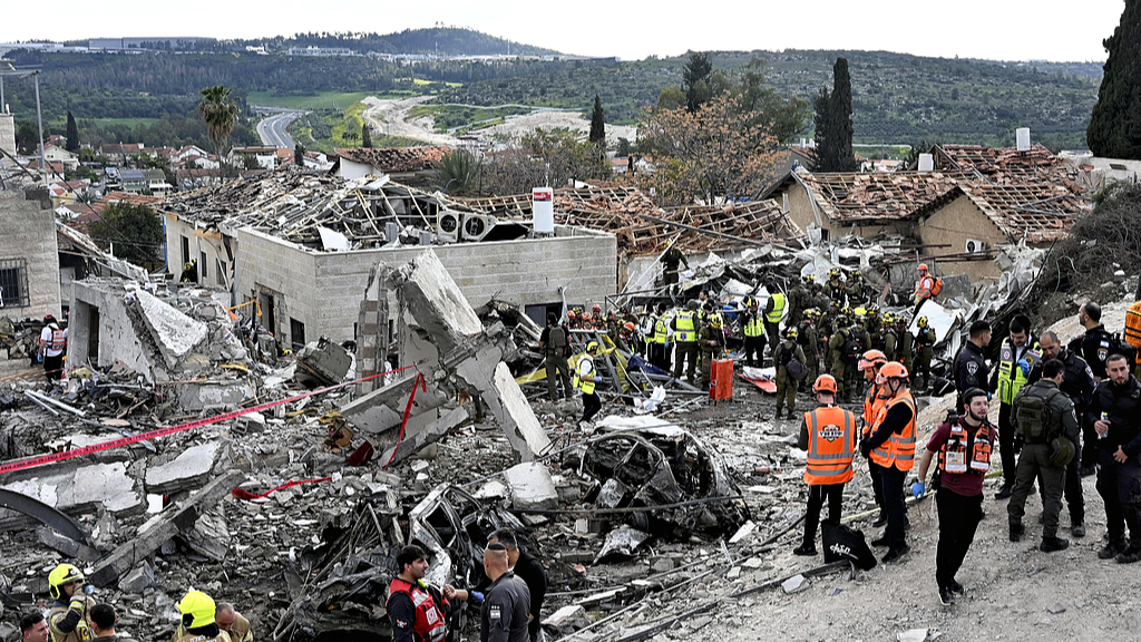 Rescue workers searched for missing people around a building destroyed by an Iranian missile attack, In Beit Shemesh, central Israel, March 1, 2026. /CFP