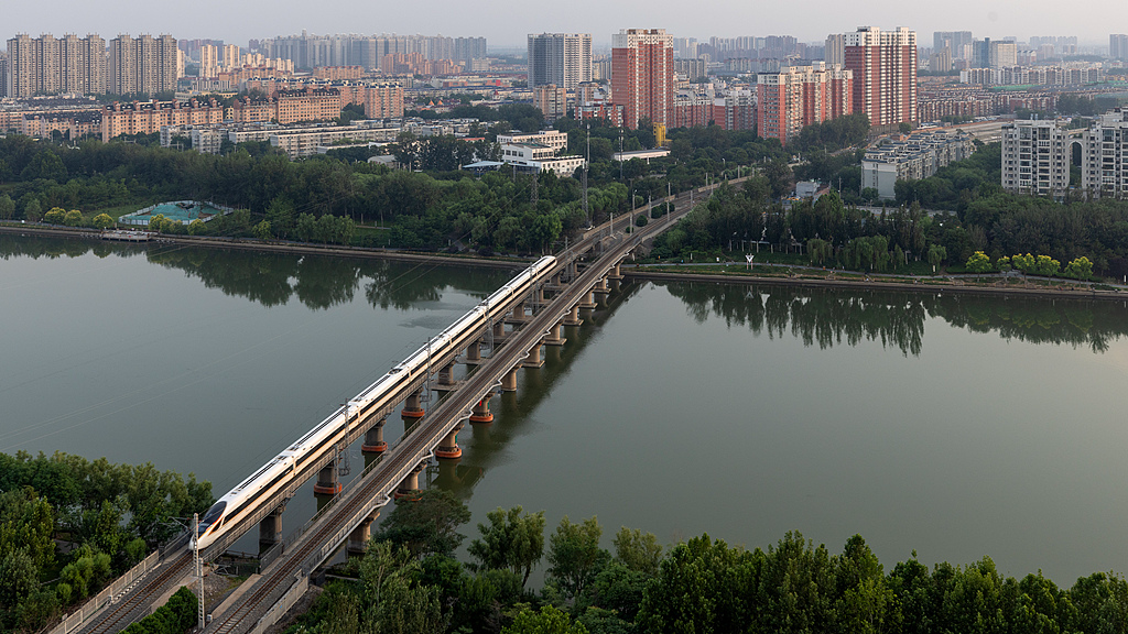 A train passes through the Grand Canal in Tongzhou District, Beijing, June 17, 2025. /CFP

