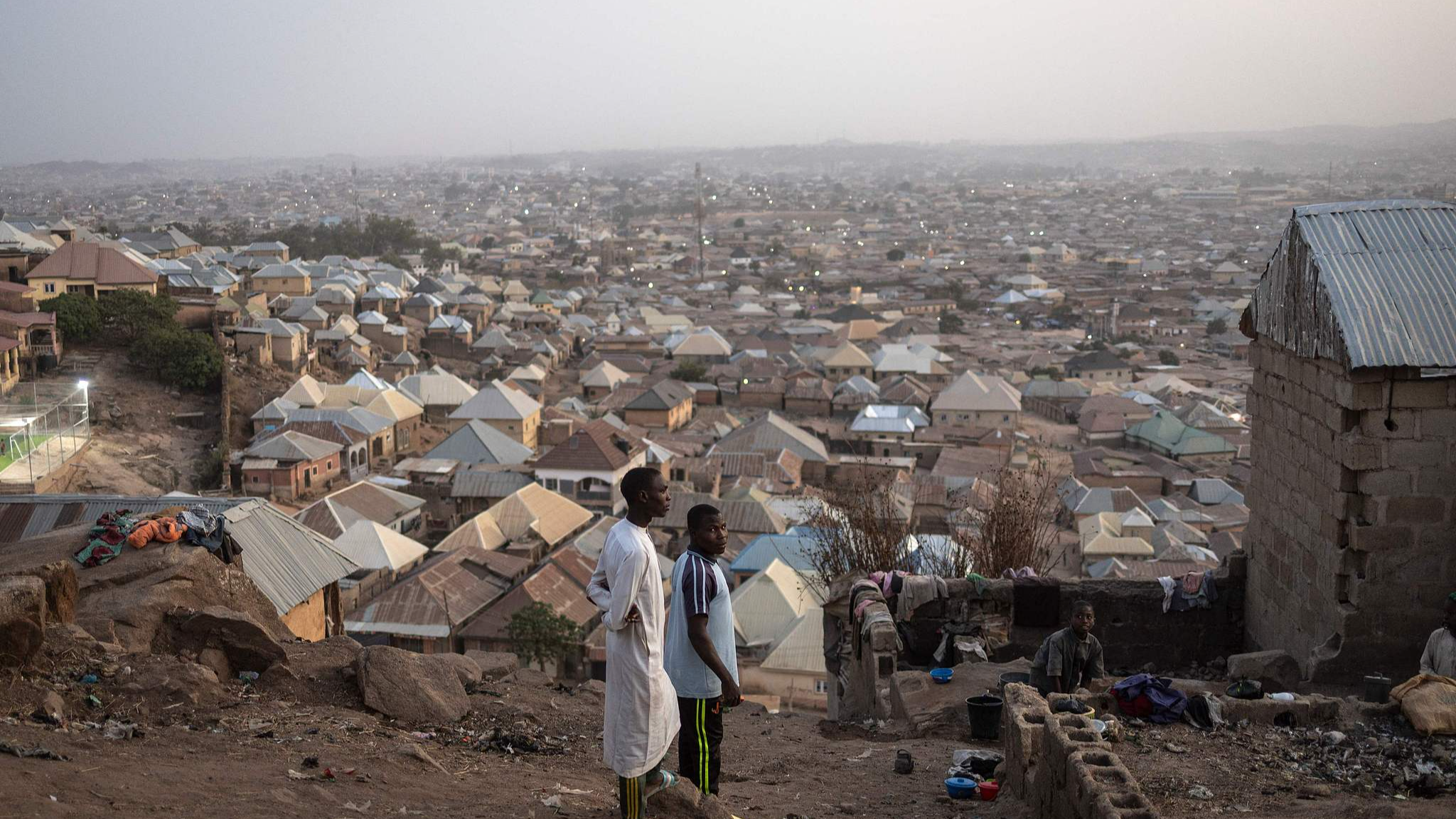 Several men atop Zinariya hills in Jos, Nigeria, on February 28, 2025. /CFP