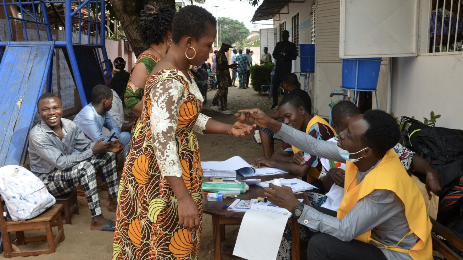 FILE: A poll worker applies ink to a voter’s finger during parliamentary elections in Cotonou, Benin, on January 8, 2023. /Reuters