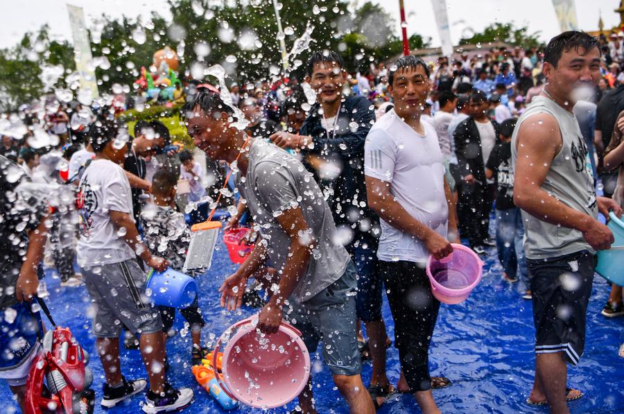 Tourists and local people celebrate the water-splashing festival at a square in Mangshi City, Dehong Dai and Jingpo Autonomous Prefecture, southwest China's Yunnan Province, April 12, 2024. /Xinhua