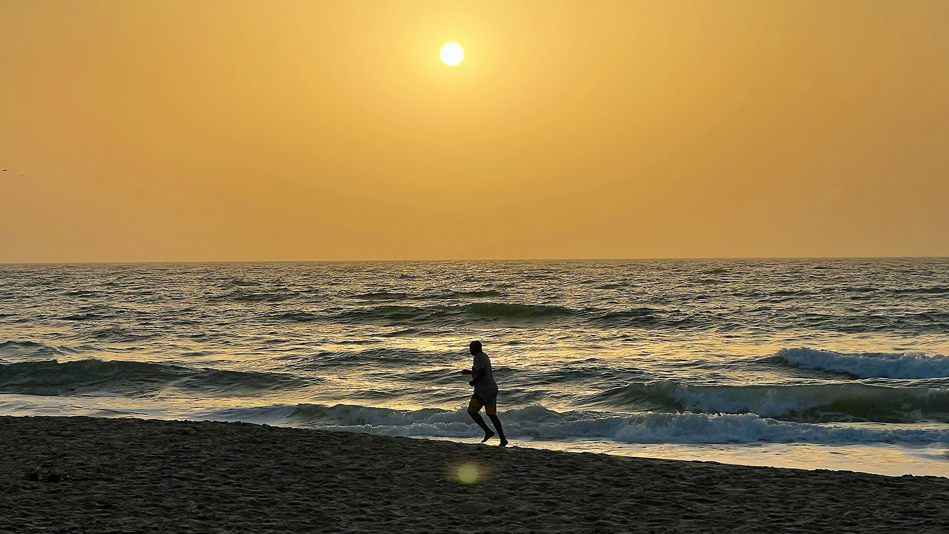 A person jogging on a beach in Banjul, The Gambia, April 16, 2026. /CGTN Africa