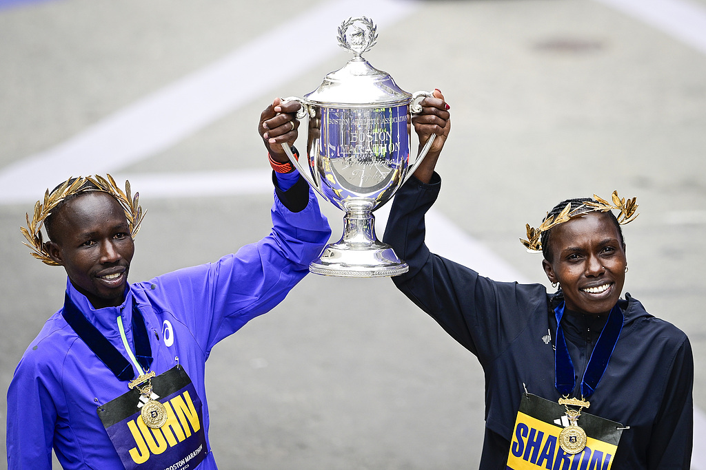 John Korir of Kenya (left) and Sharon Lokedi of Kenya pose for a portrait during a trophy presentation after taking first place in the men's and women's divisions during the 130th Boston Marathon on April 20, 2026 in Boston, Massachusetts. /CFP