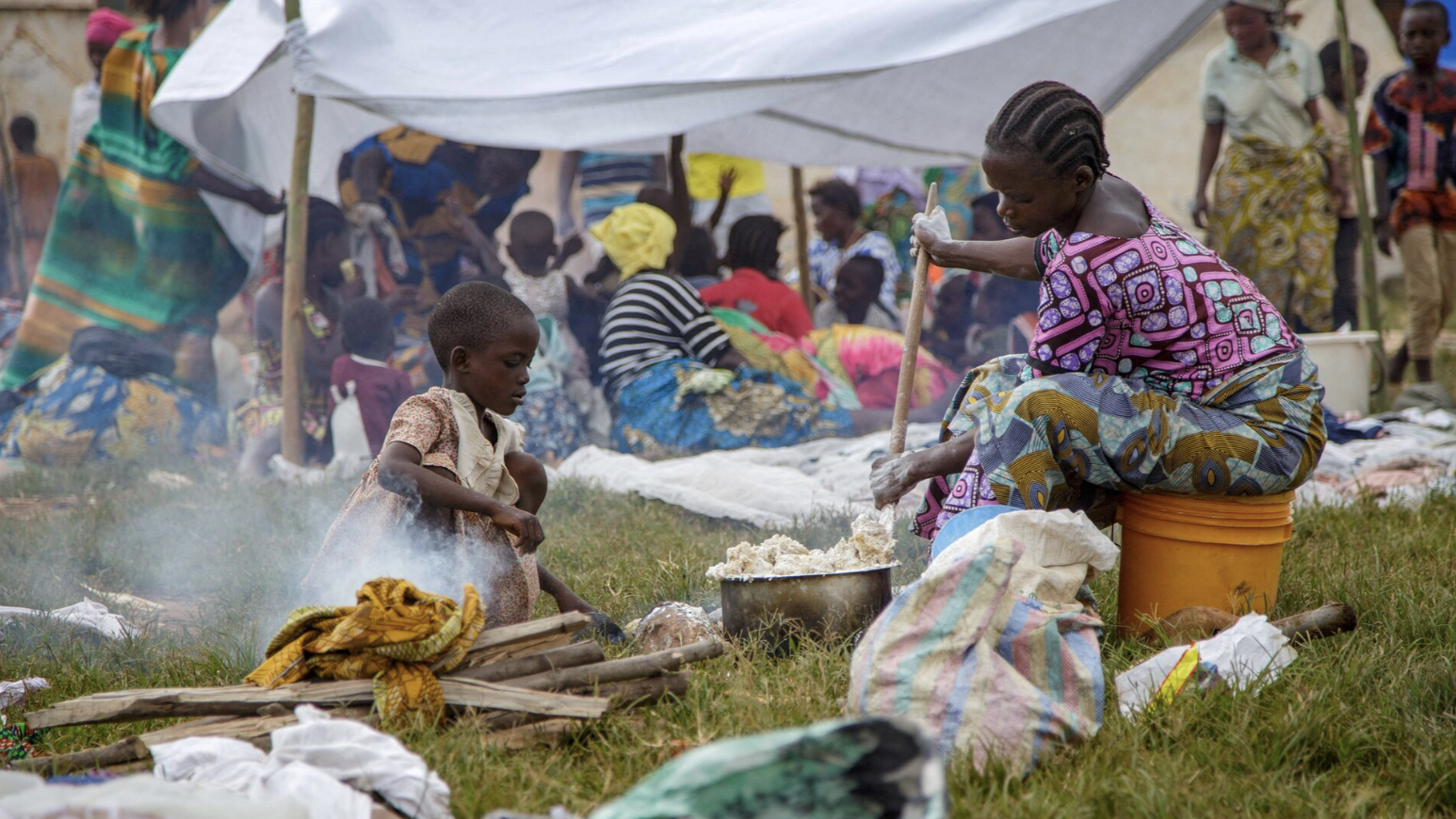 A Congolese woman prepares a meal near a temporary shelter at Rugombo Stadium, after fleeing from renewed clashes between M23 rebels and the Armed Forces of the Democratic Republic of the Congo, in Rugombo commune of Cibitoke Province, Burundi, February 18, 2025. /Reuters