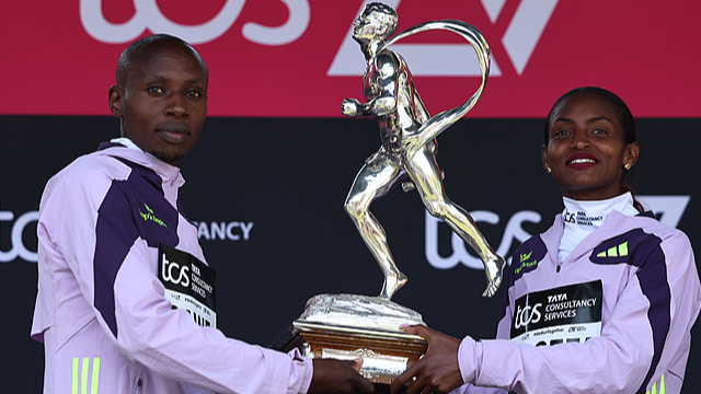 Winners Sabastian Sawe of Kenya (L) and Tigst Assefa of Ethiopia (R) hold a sporting life trophy after the London Marathon in London, England, April 26, 2026. /CFP