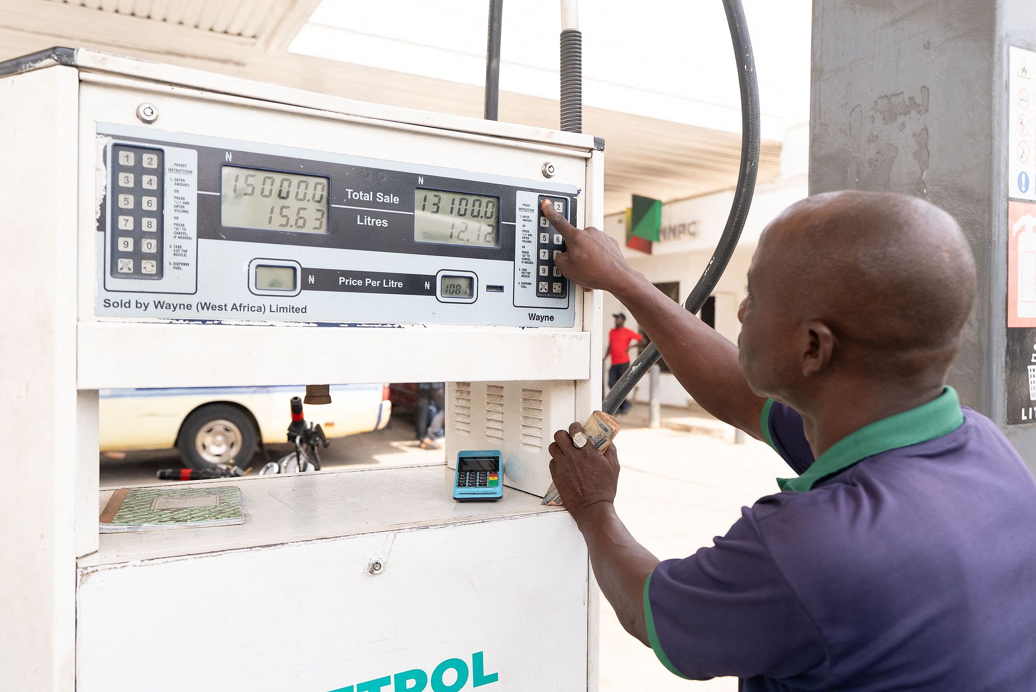 A fuel attendant operates a pump at a fuel station in Abuja, Nigeria, March 9, 2026. /CFP 