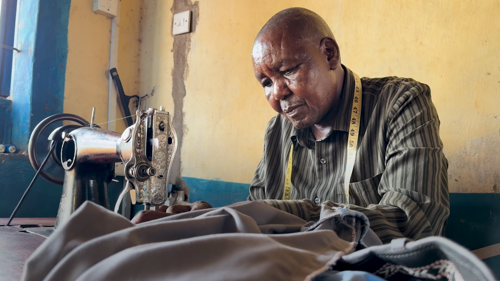 William Ndolo, tailor, at his shop in Kitonyoni village in Makueni county, Kenya. /CGTN Africa