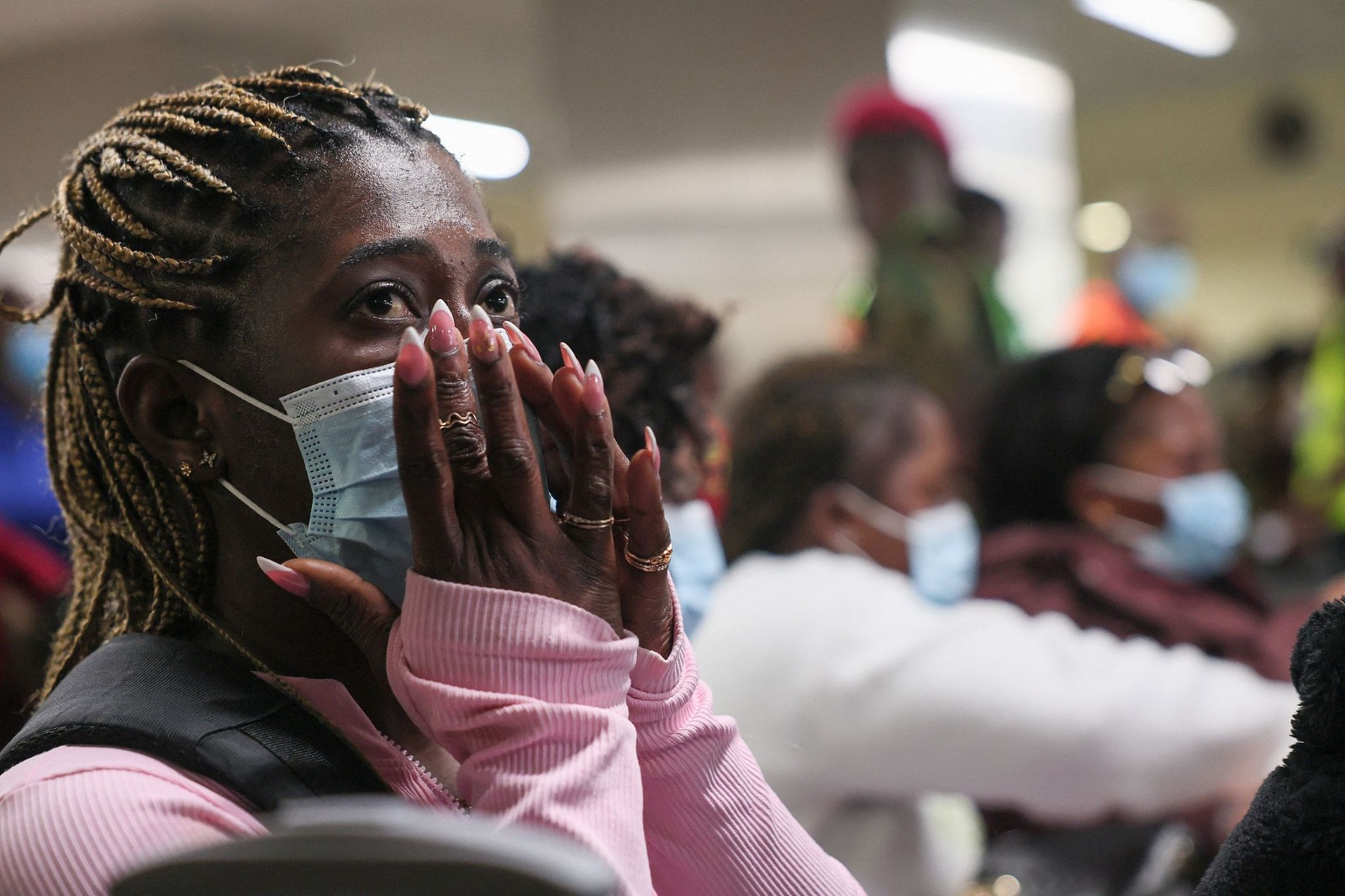 A woman reacts as Ghanaian nationals evacuated from South Africa following xenophobic attacks wait upon arrival at Accra International Airport on May 27, 2026. /CFP