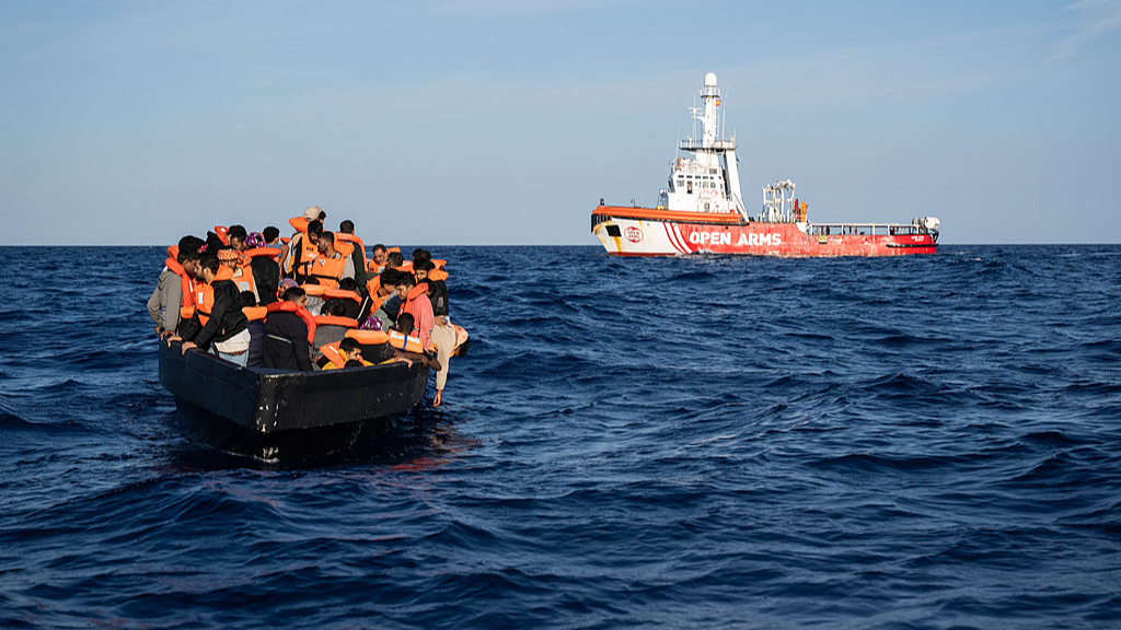 A wooden boat carrying 58 migrants, including 18 unaccompanied minors from Sudan, Eritrea, Egypt, Bangladesh, and Somalia, is rescued by the NGO vessel Open Arms, in the central Mediterranean, June 3, 2026. /CFP