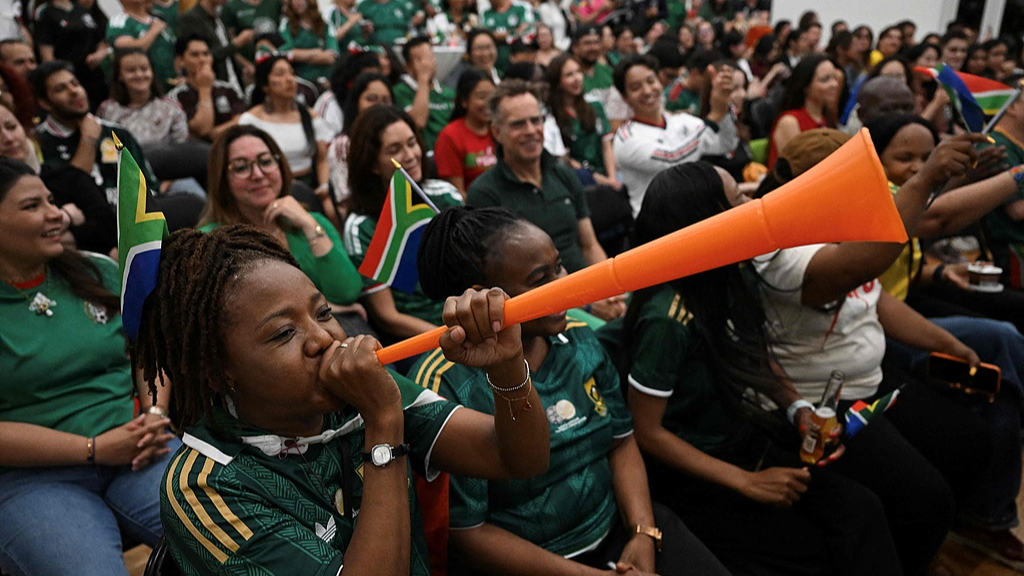 Mexican and South African fans react as they watch a live broadcast of the FIFA World Cup Group A match between Mexico and South Africa at the Mexican embassy in Beijing on June 12, 2026. /CFP