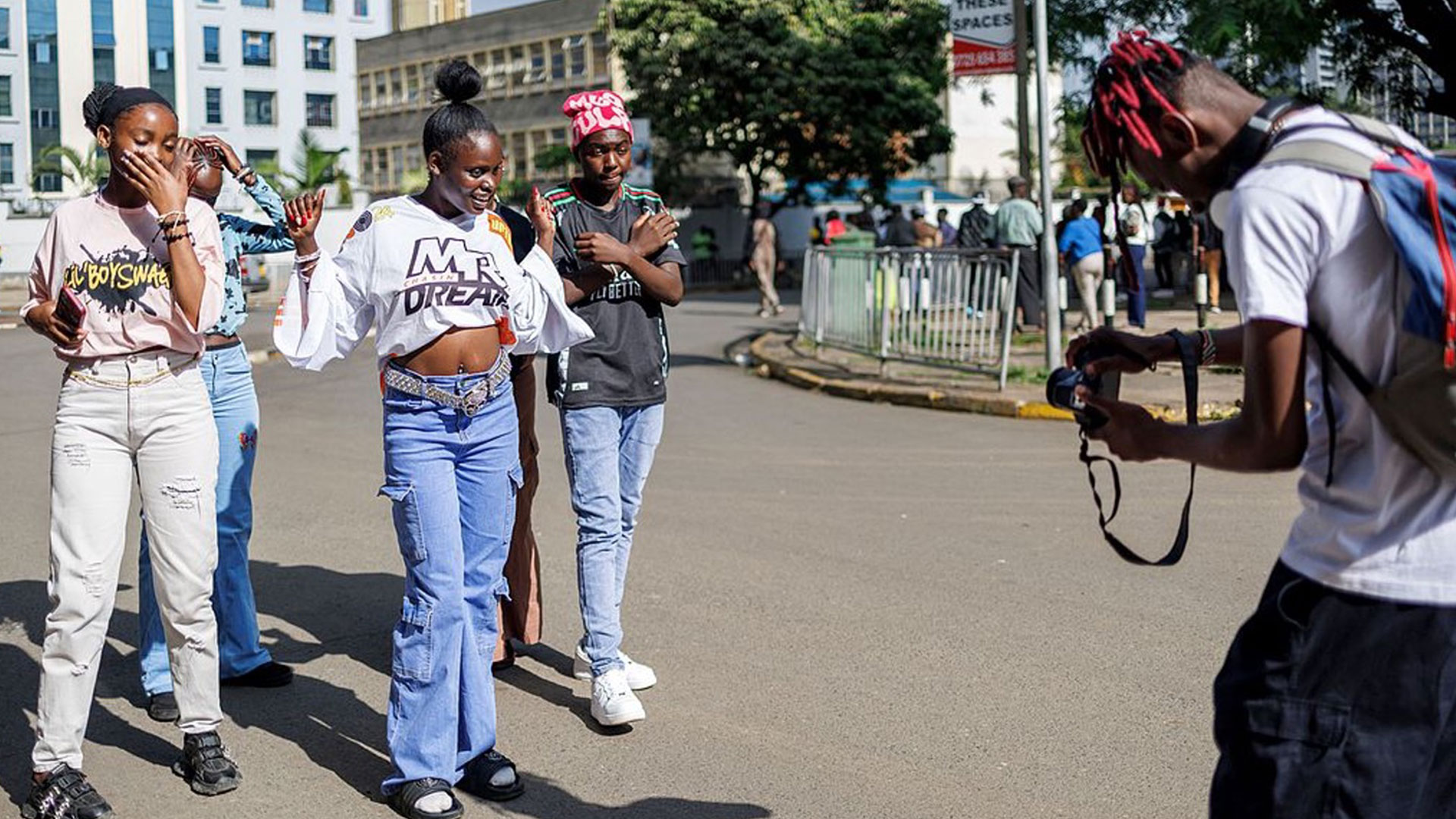 Social media content creators perform for a street photographer during a dance video shoot in Nairobi’s central business district on November 17, 2024. /CFP