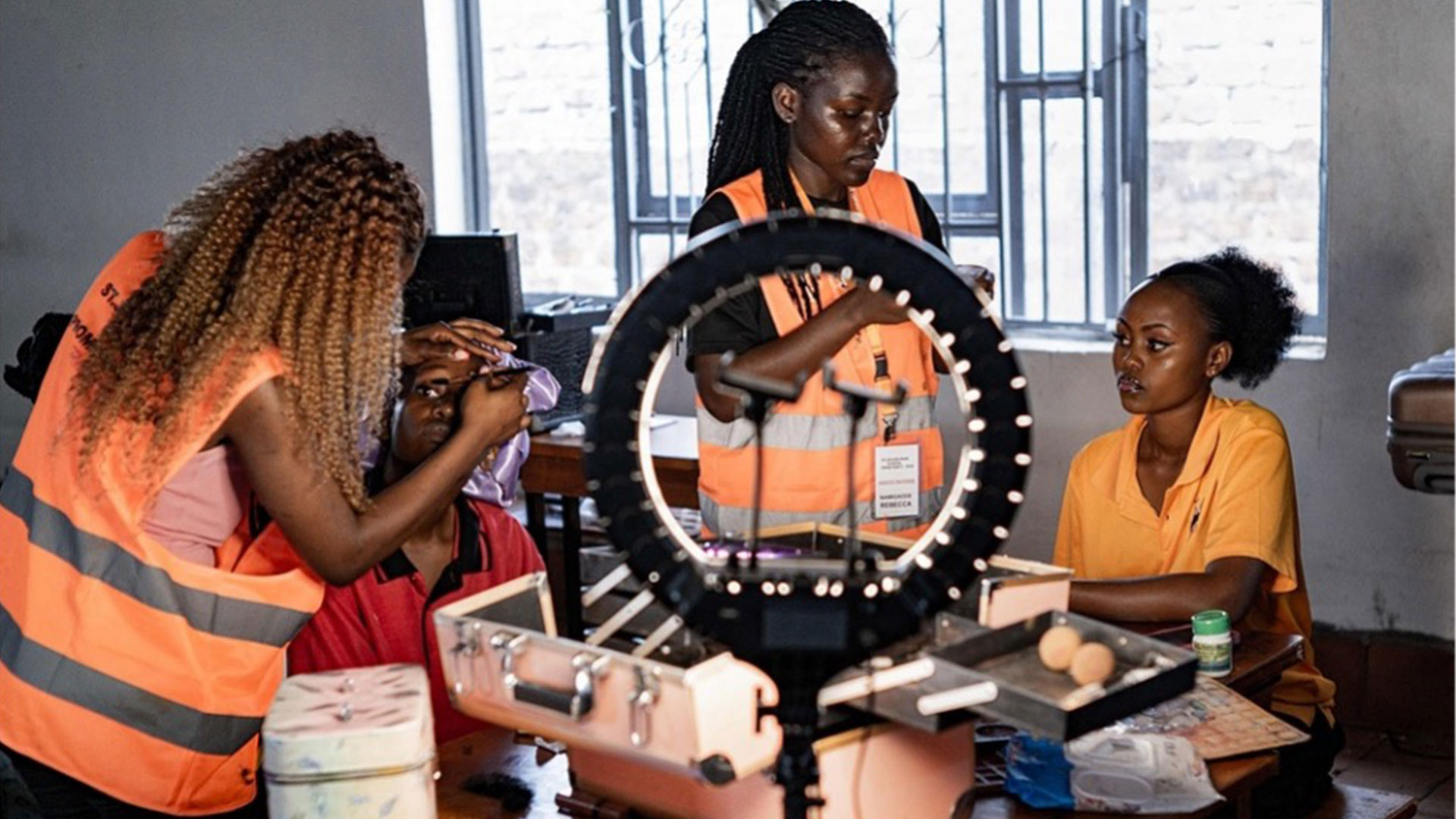 Senior-year students at St. Julian High School apply makeup and style their hair as they get ready to attend their prom in Gayaza on May 19, 2026. /CFP