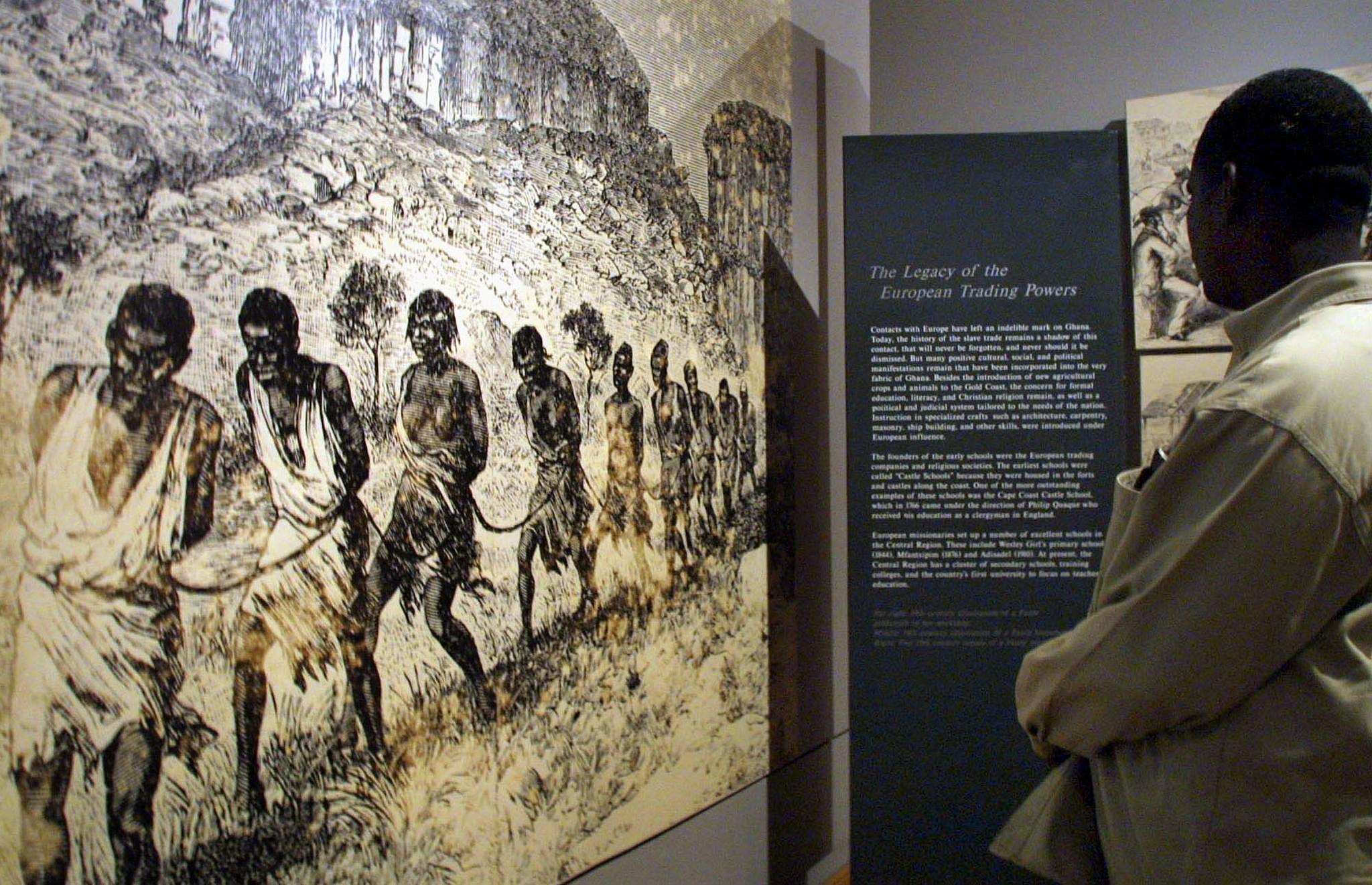 File photo: A man watched historical footage of slavery inside Cape Coast Castle in Ghana, August 16, 2001. /CFP