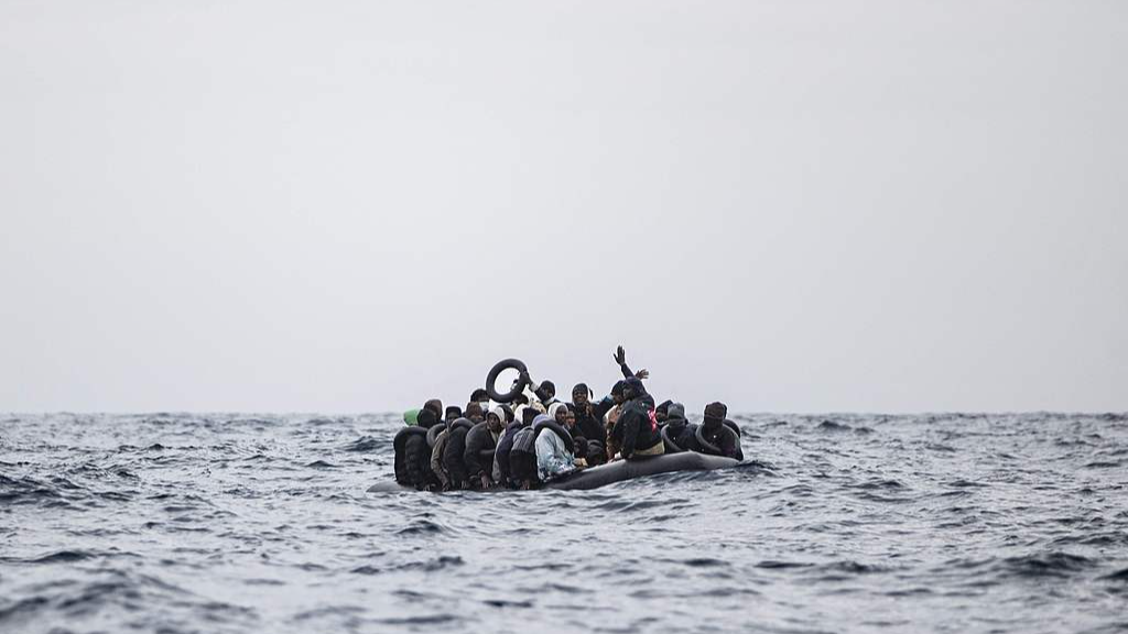 Migrants waited in a rubber dinghy for rescue by the crew of the rescue ship 