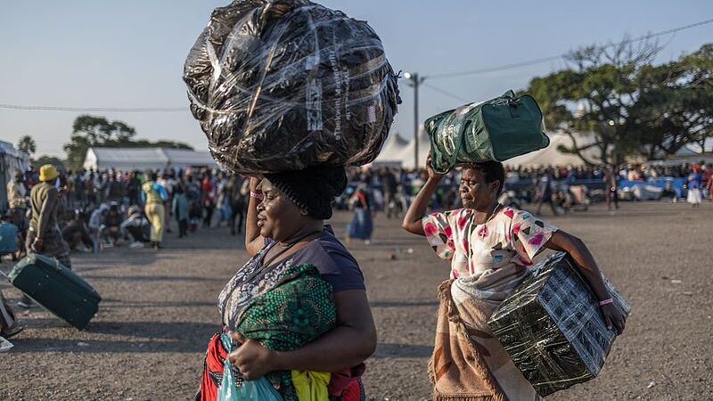 Durban, South Africa, displaced foreign nationals carried goods on their heads as they took refuge at the old Durban Drive Inn in Durban, June 22, 2026. /VCG