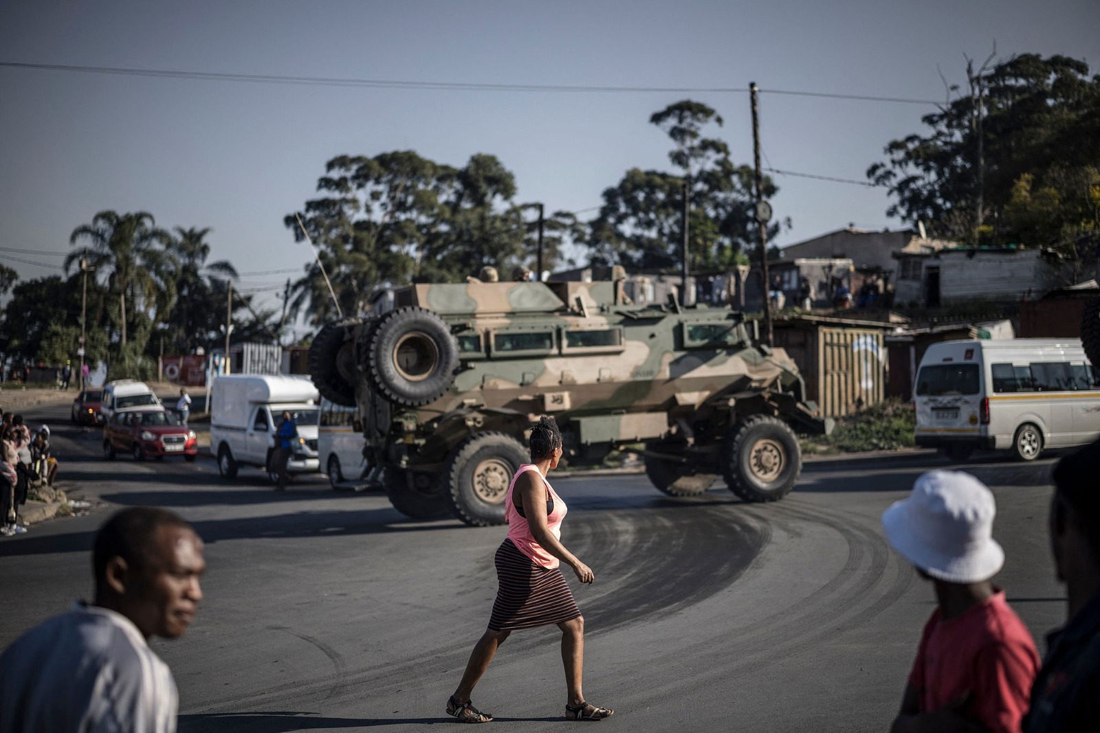 Pedestrians walk past an armored vehicle of the South African National Defence Forces (SANDF) patrolling in Durban, South Africa, on July 1, 2026. /CFP