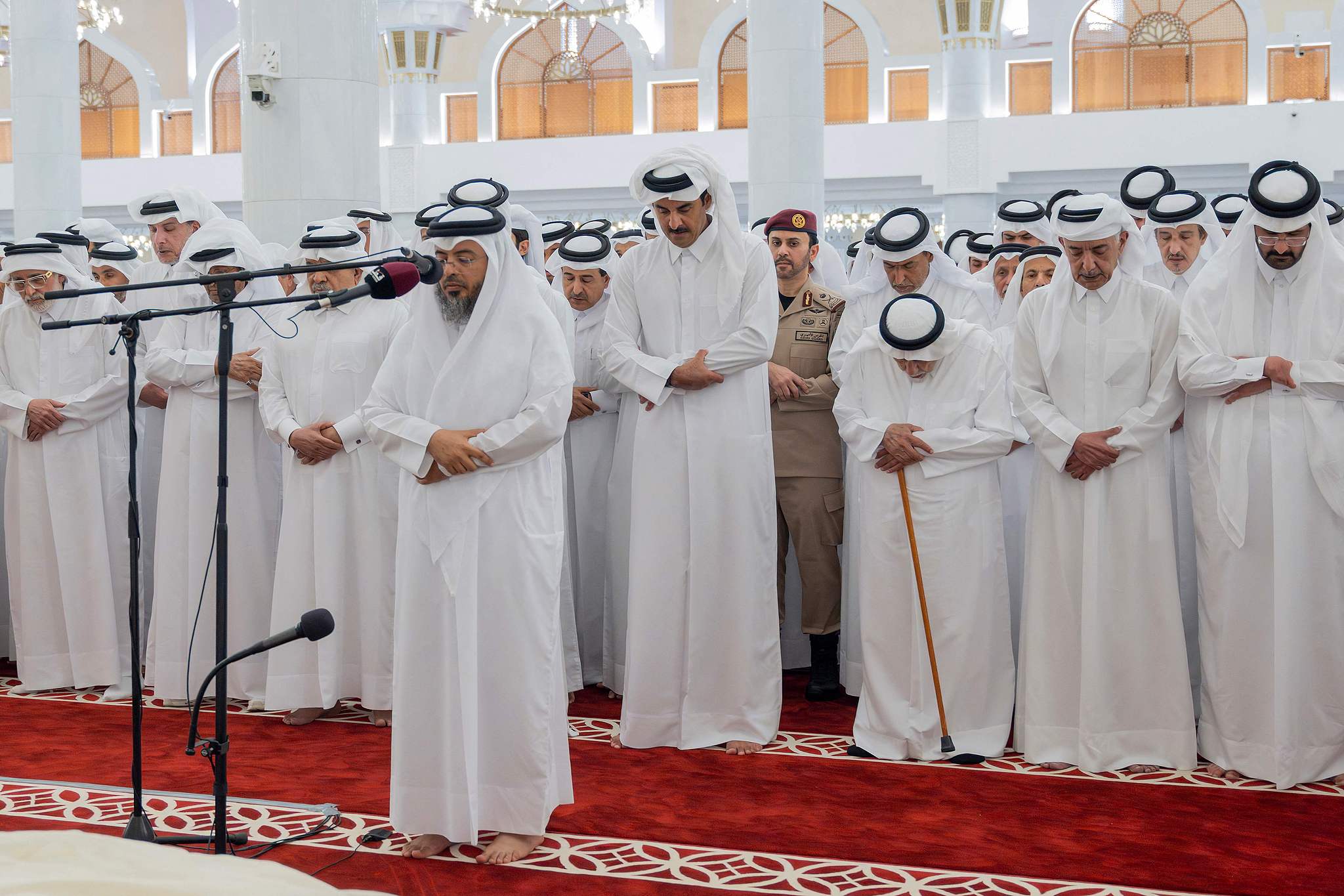 This handout photograph taken and released by Qatar's Amiri Diwan shows Qatar's Emir Sheikh Tamim bin Hamad Al Thani (C) attending the funeral of his father, former leader Sheikh Hamad bin Khalifa Al Thani, at the Imam Mohammed ibn Abd Al Wahhab Mosque in Doha, July 12, 2026. /CFP