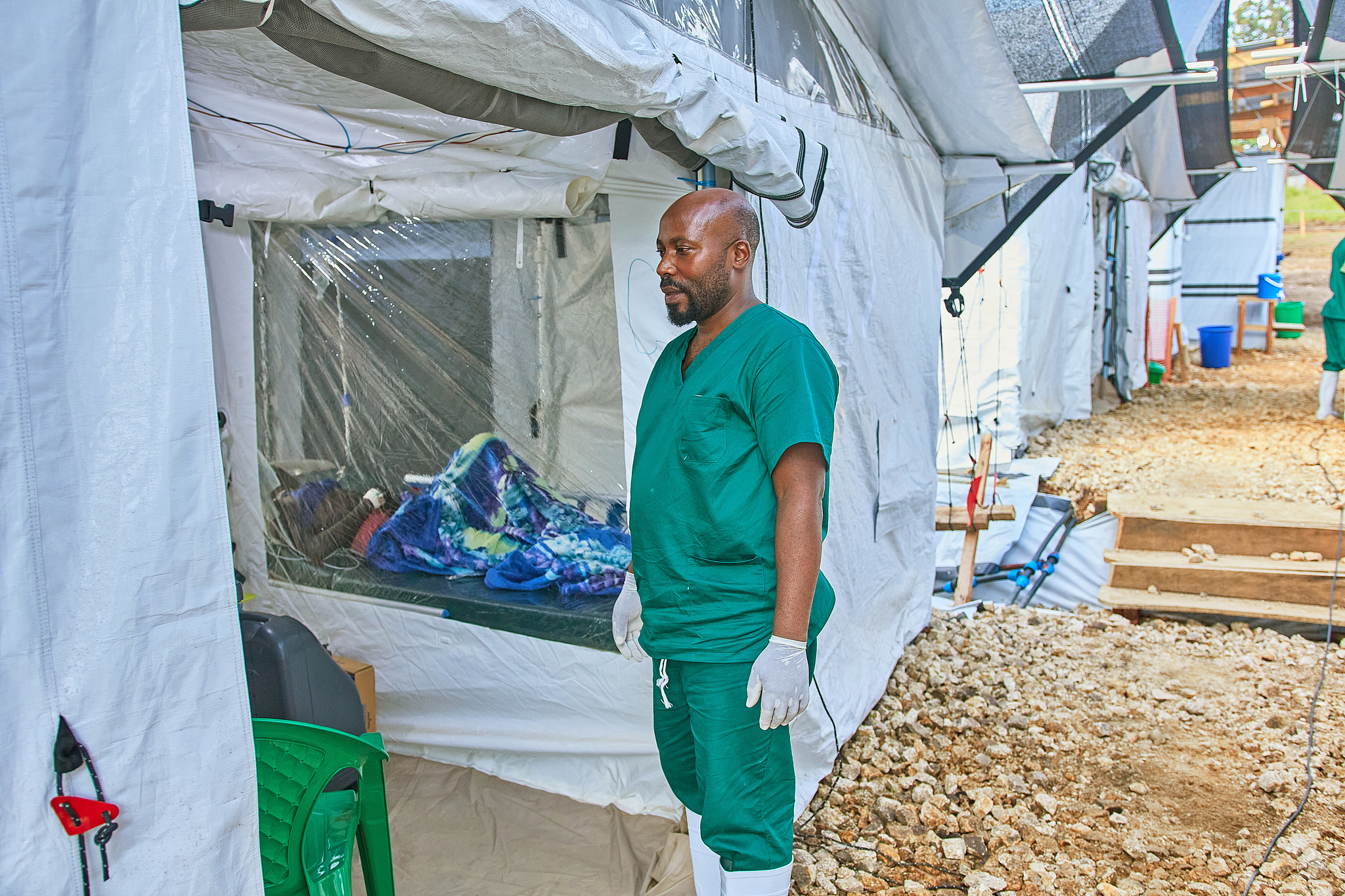 A healthcare worker stands near a patient at the Evangelical Medical Center, in Bunia, DR Congo, on July 3, 2026. /CFP