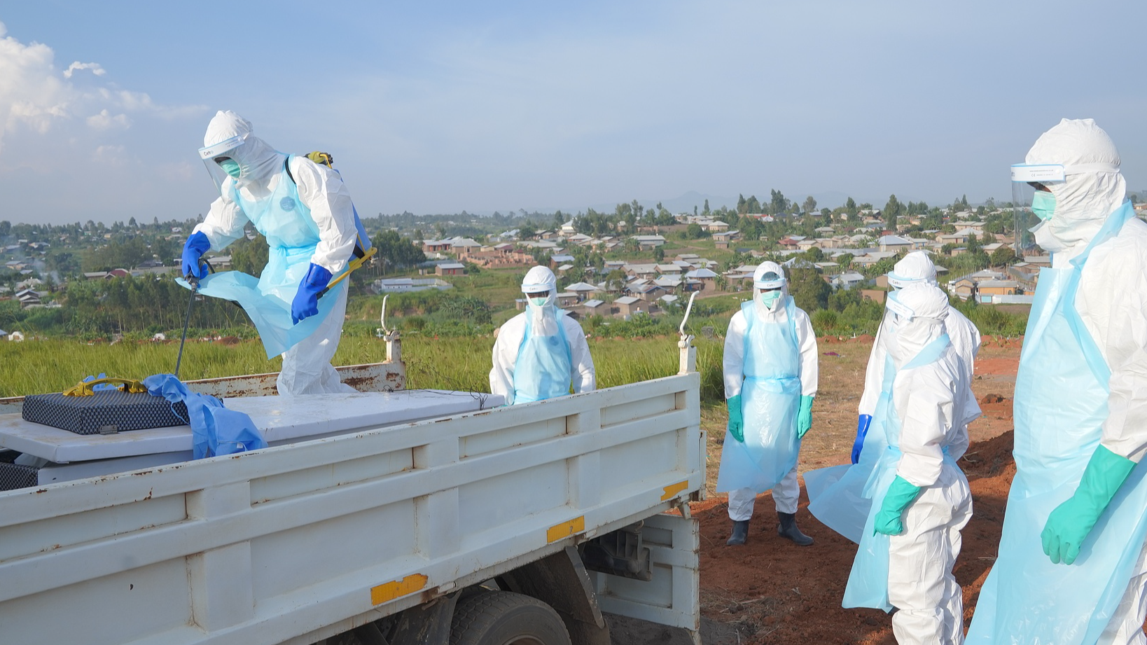 A health worker sprays the coffin containing the remains of Jacques Lobo Dhena, who died of Ebola, during a burial service in Bunia, Ituri province, eastern DRC, August 12, 2026. /CFP