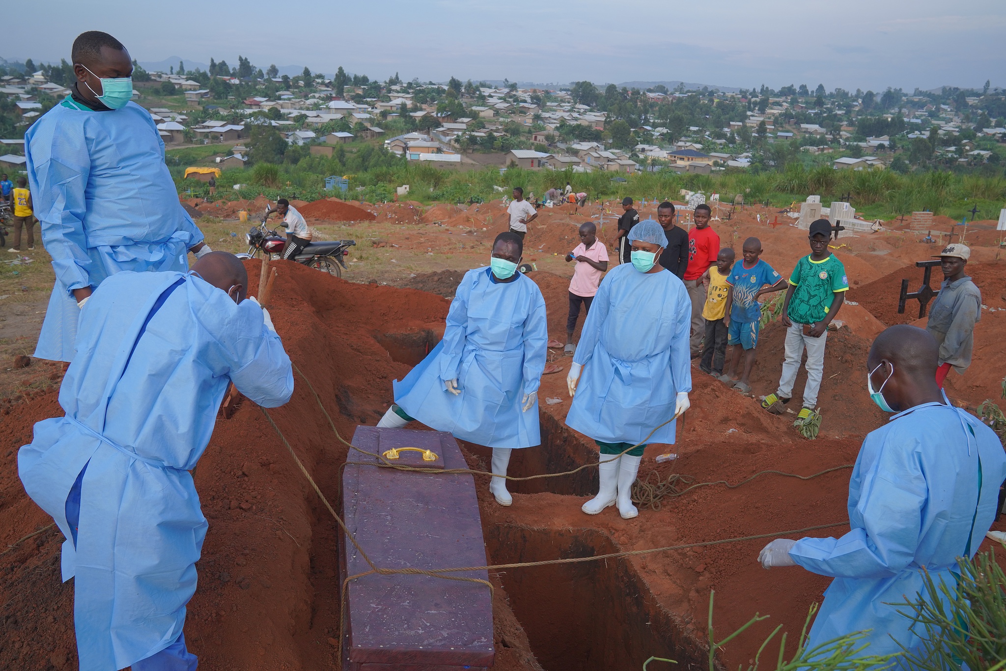 People dressed in protective gear prepare to lower the coffin containing the remains of six-year-old Baudjo Baraka Jules, who died of Ebola, in Ituri Province, DR Congo, August 18, 2026. /CFP