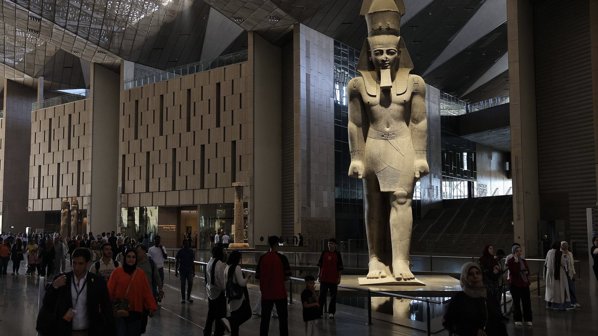 People walked past the statue of Ramses II at the entrance of the Grand Egyptian Museum in Giza, Egypt, July 6, 2026. /CFP