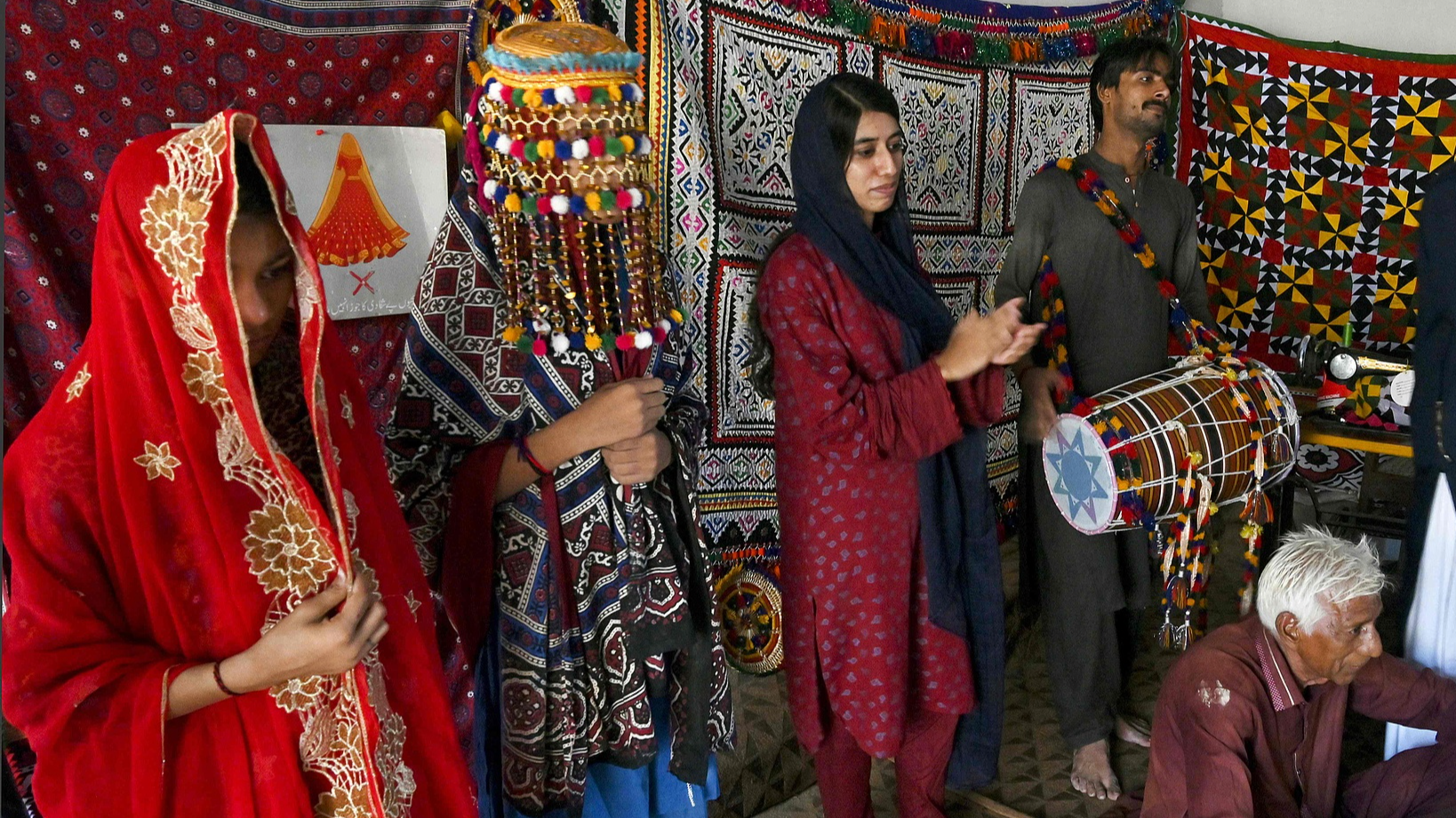 Mashooque Birhmani, founder of the NGO Sujag Sansar, applauds during a theatrical rehearsal in Dadu district, Sindh province, Pakistan, August 4, 2024. /CFP