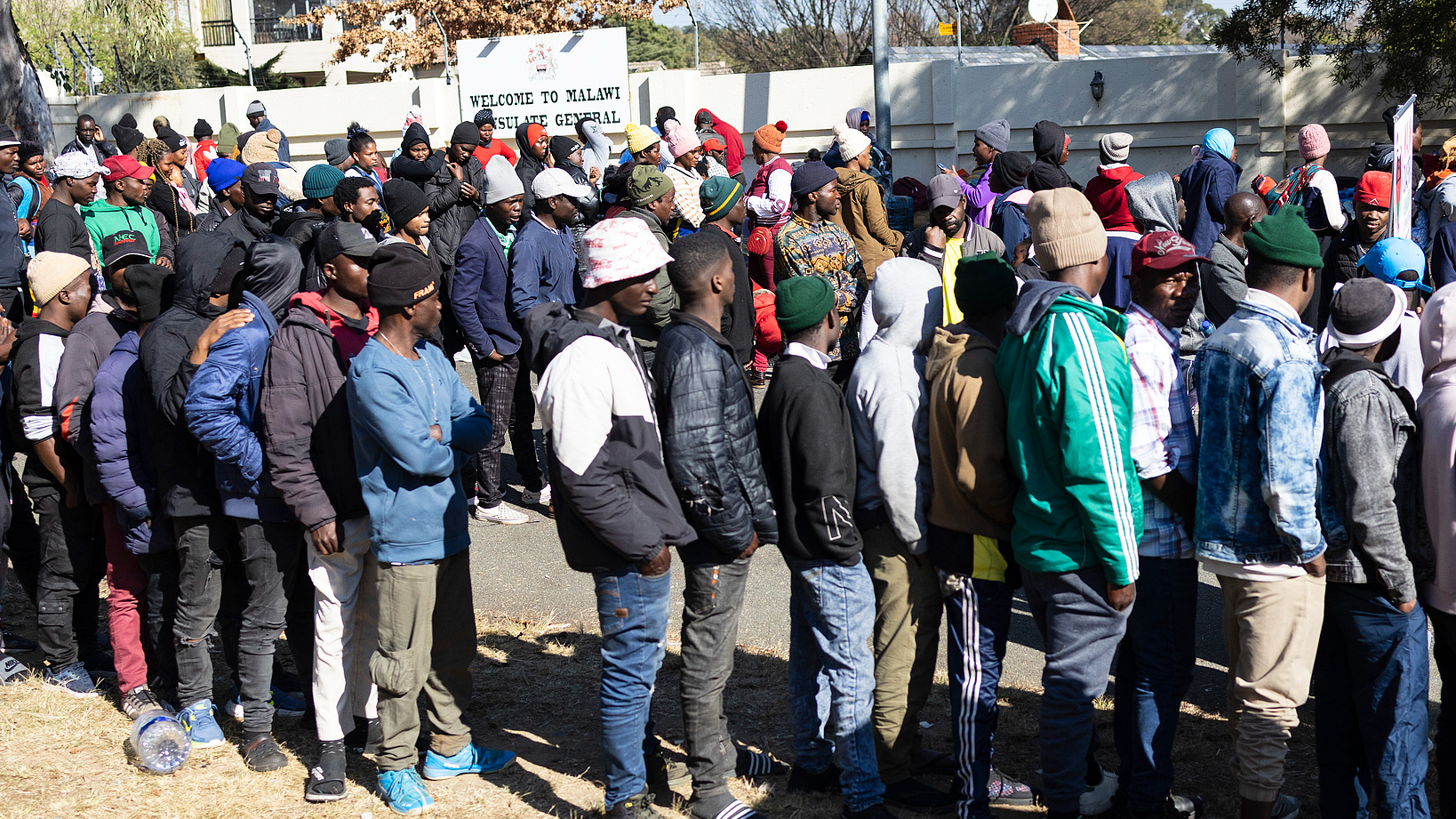 Malawi refugees gather outside the Malawi Embassy ​​in Johannesburg, South Africa, attempting to return home by bus before the nationwide anti-immigrant movement is scheduled to close, June 29, 2026. /CFP